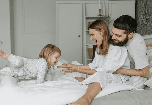 Family relaxing comfortably at home using Glacier Breeze – portable cooler in action